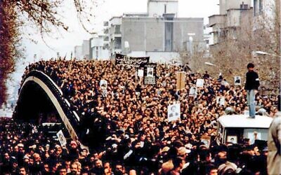 Demonstration in Iran during the revolution, with protesters holding up placards featuring the Ayatollah  (Wikipedia/  GNU Free Documentation License/Author: Unknown via Jewish News)