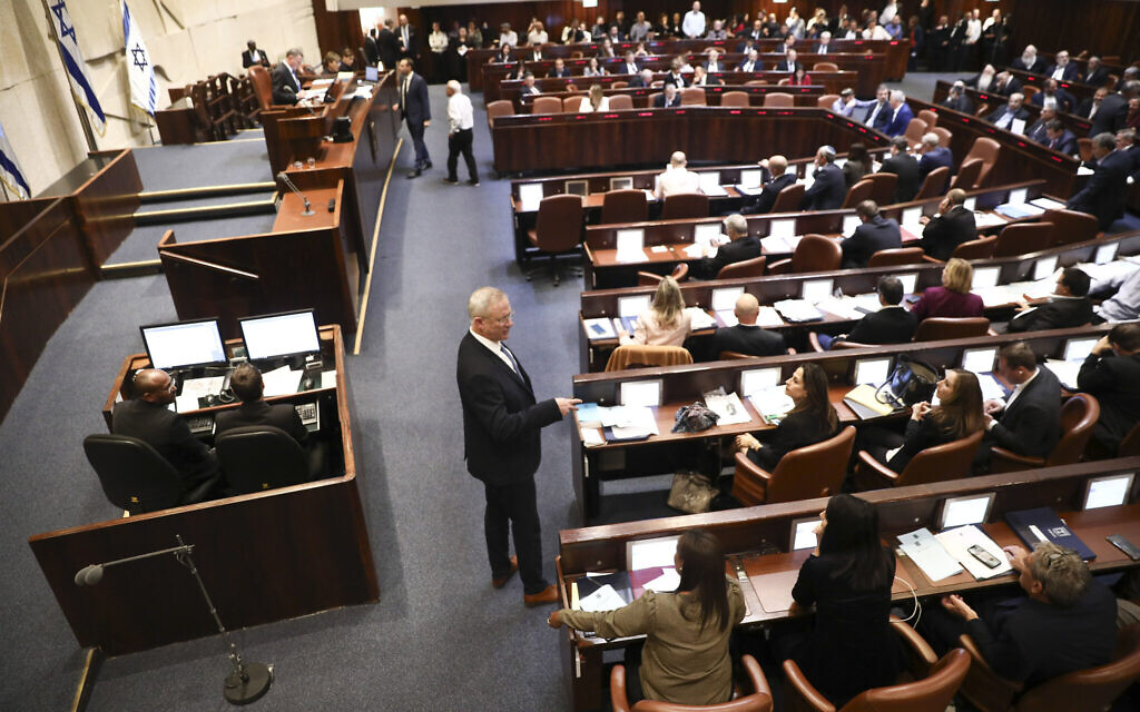 Blue and White party leader Benny Gantz, center, stands during a Knesset session in Jerusalem, Wednesday, Dec. 11, 2019. The Israeli parliament began voting to dissolve itself on Wednesday and pave the path to an unprecedented third election within a year. (AP Photo/Oded Balilty)