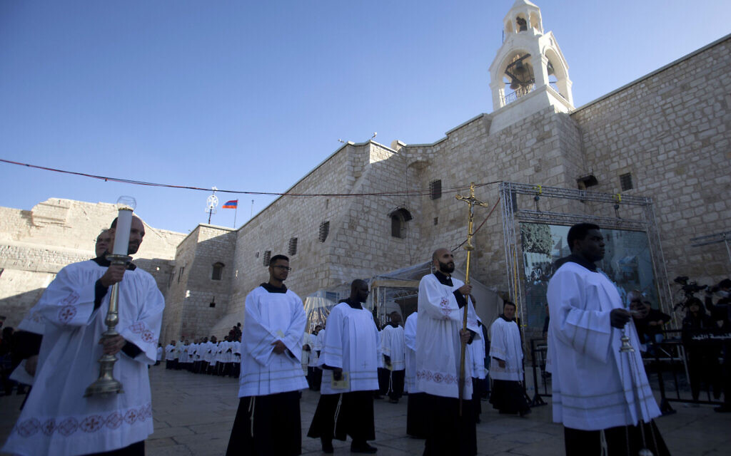 Clergymen participate in Christmas celebrations outside the Church of the Nativity, built atop the site where Christians believe Jesus Christ was born, on Christmas Eve, in the West Bank City of Bethlehem, Tuesday, Dec. 24, 2019. (AP Photo/Majdi Mohammed)