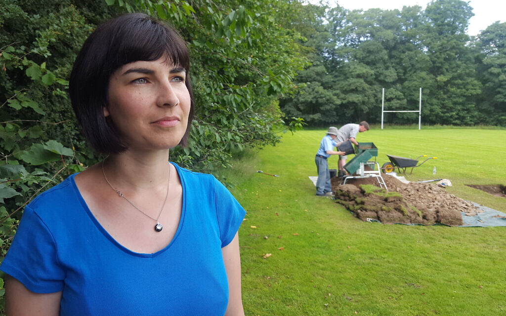Dr Caroline Sturdy-Colls in front of dig site (Credit:  Rare TV,  Digging for Britain)