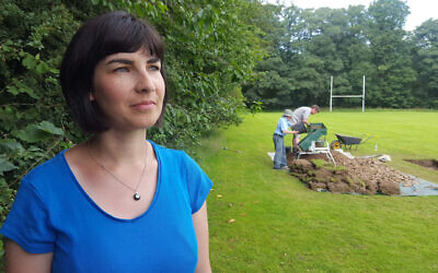 Dr Caroline Sturdy-Colls in front of dig site (Credit:  Rare TV,  Digging for Britain)