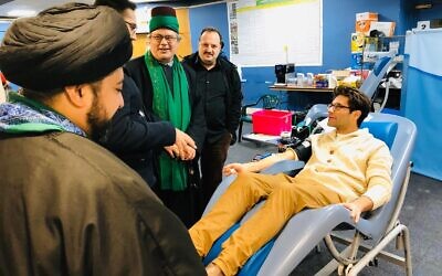 Rabbi Natan Levy gives blood at Golders Green's Islamic centre