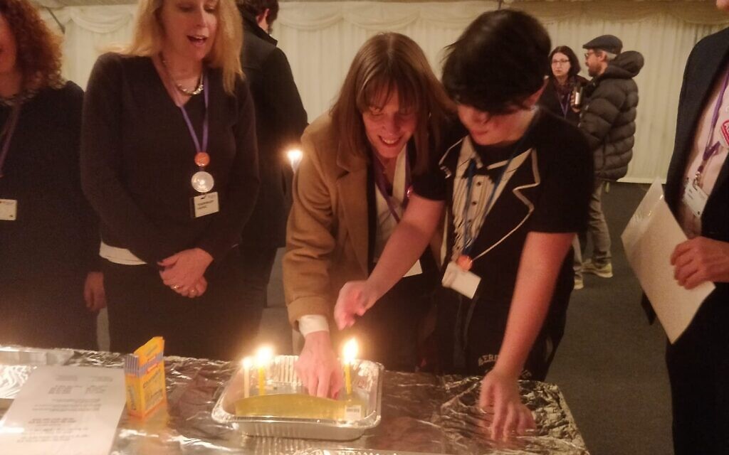 Jess Phillips lights the Chanukiah with her son