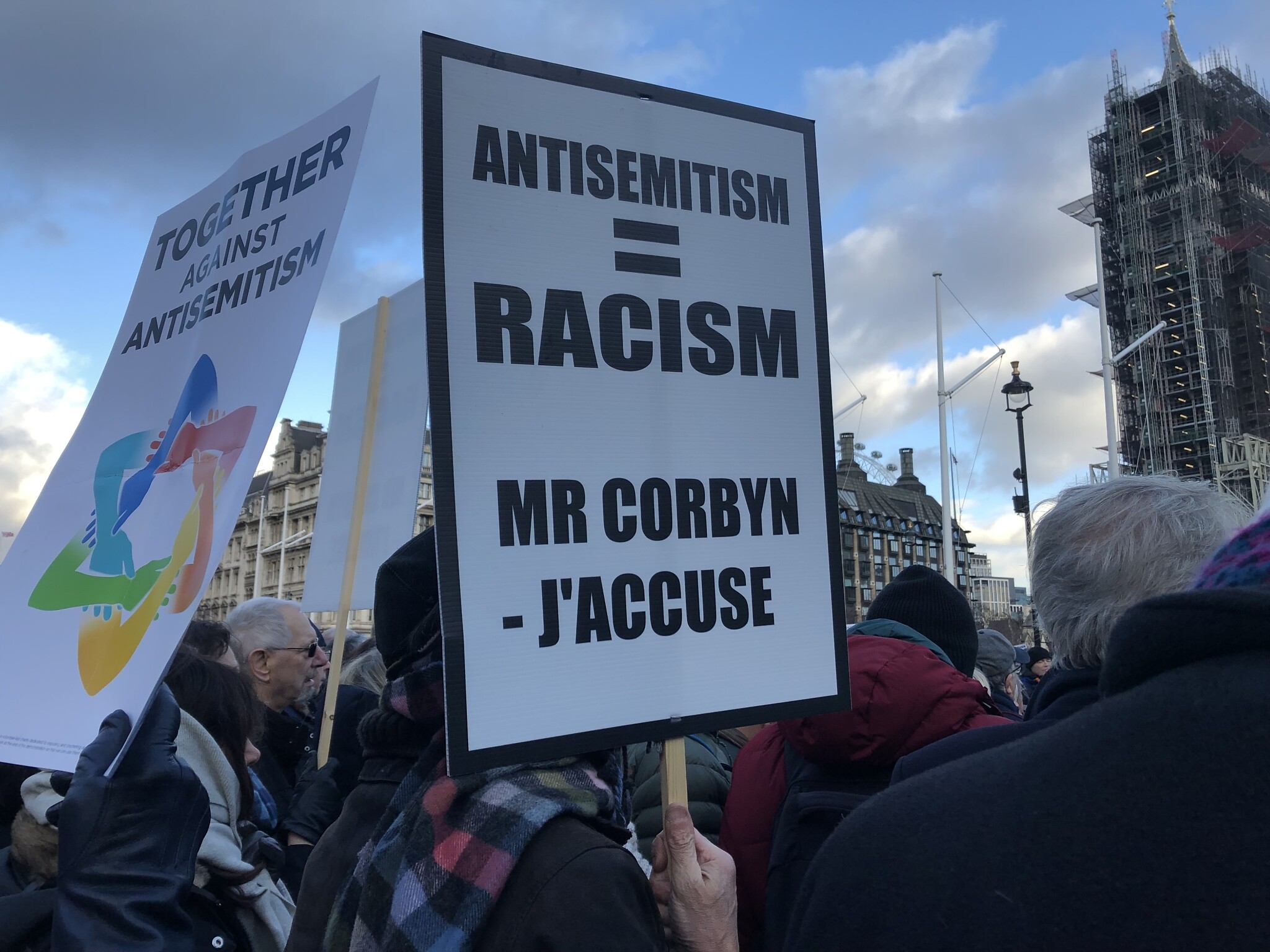Placard held at Westminster protest against antisemitism
