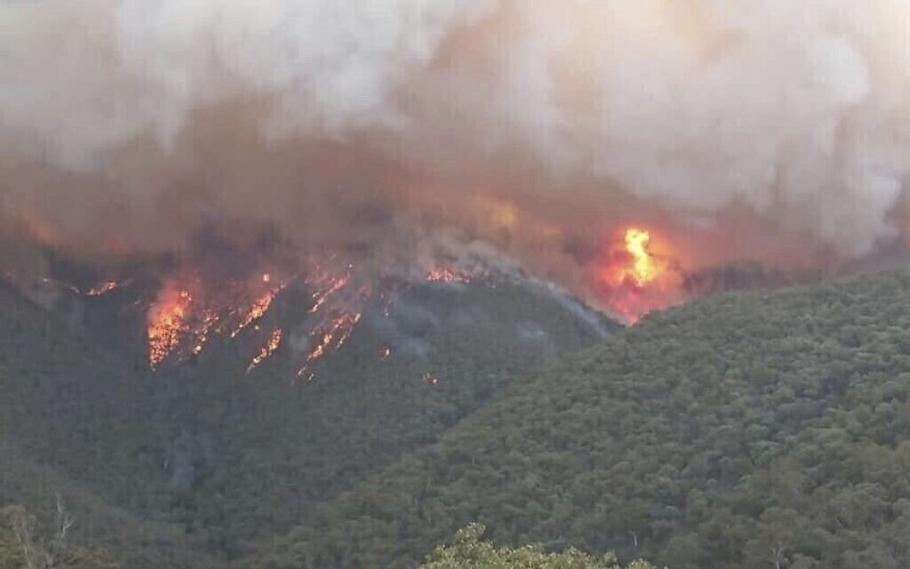 In this image released from the Department of Environment, Land, Water and Planning in Gippsland, Australia, smoke rises from wildfires burning in East Gippsland, Victoria.   (DELWP Gippsland via AP)
