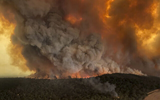 Aerial photo, shows wildfires rage under plumes of smoke in Bairnsdale, Australia.  (Glen Morey via AP)