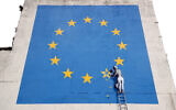 File photo dated 08/05/17 of a Banksy artwork painted on a former amusements arcade near Dover's busy ferry terminal showing an EU flag with a workman chipping away one of the stars. Three and a half years after the referendum, the UK will leave the European Union at 11pm on Friday. PA Photo. Issue date: Friday January 31, 2020. See PA story POLITICS Brexit. Photo credit should read: Gareth Fuller/PA Wire