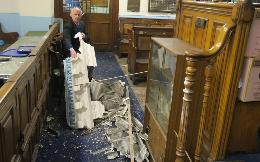 Leon Silver, president of Whitechapel’s East London Synagogue, examines the damage to the historic building. (Credit: Mike Brooke/East London Advertiser)