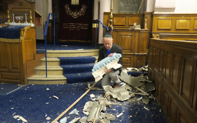 Leon Silver, president of Whitechapel’s East London Synagogue, examines the damage to the historic building. (Credit: Mike Brooke/East London Advertiser)
