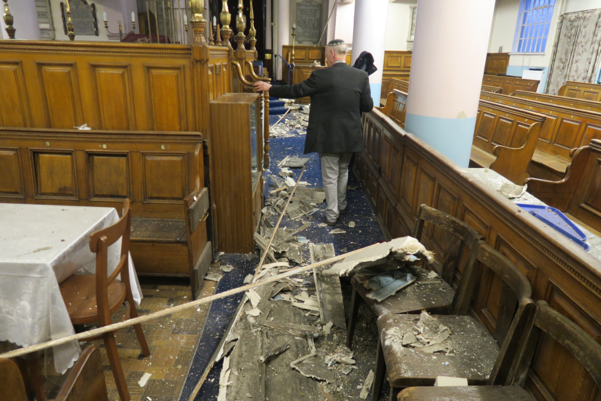 Leon Silver, president of Whitechapel’s East London Synagogue, examines the damage to the historic building. (Credit: Mike Brooke/East London Advertiser)