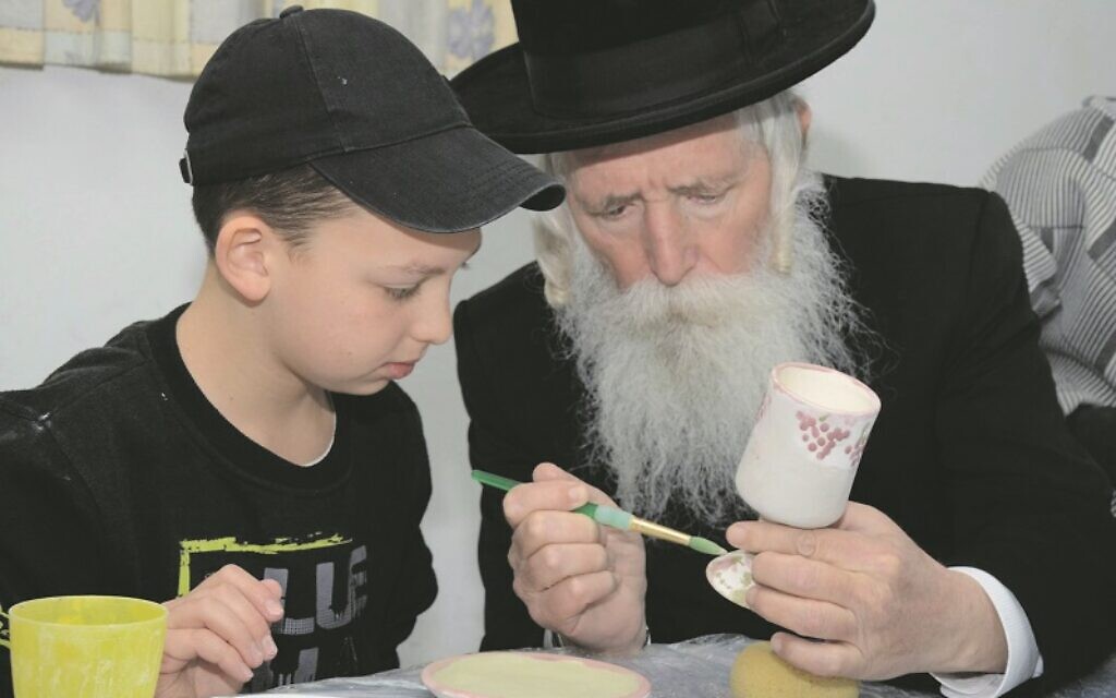 Rabbi Yitzchak Grossman, founder of Migdal Ohr, with a youngster helped by the charity Credit: Geoffrey Alan Photography