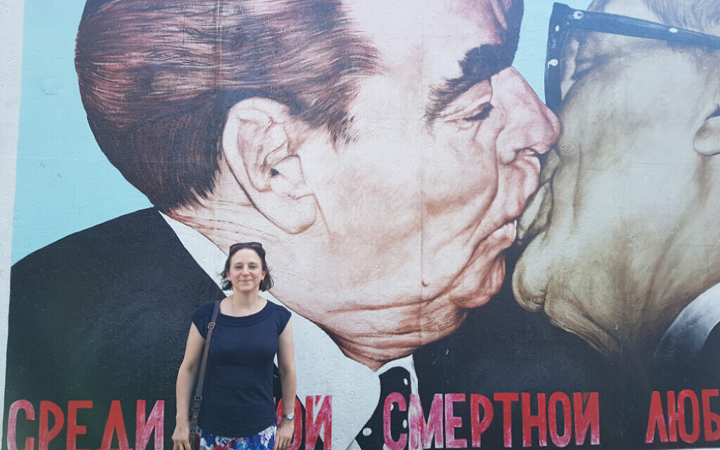 Alex at the famous mural known as My God, Help Me to Survive This Deadly Love by Dmitri Vrubel, at the East Side Gallery, featuring Soviet leader Leonid Brezhnev and East German President Erich Honecker