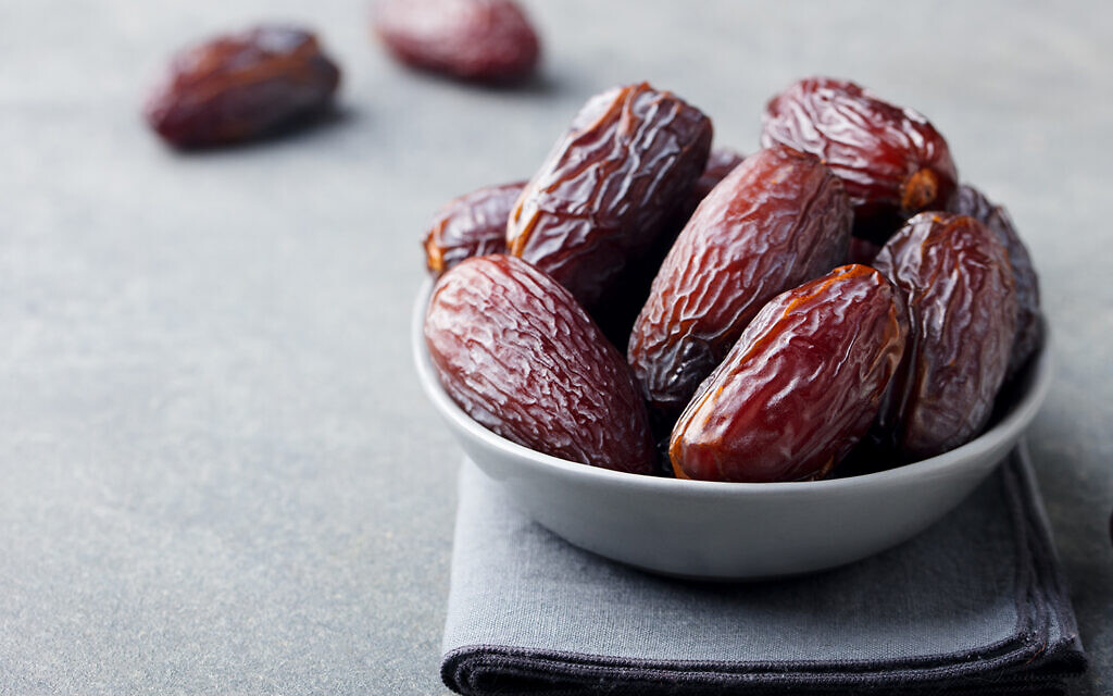 Fresh medjool dates in bowl. (Credit: Getty)