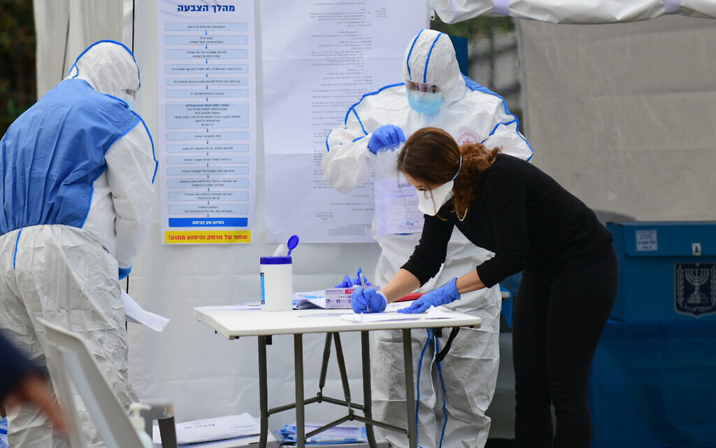 Israelis vote at polling booths specially erected for the 5,600 Israelis under self-quarantine, many of whom visited countries where the coronavirus COVID-19 is prevalent, during the parliamentary election on March 2, 2020. Photo by: Tomer Neuberg-JINIPIX