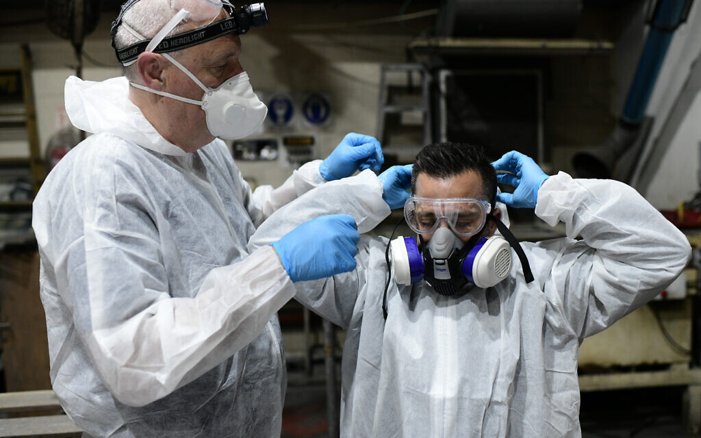 Workers wearing protective suits disinfect a bus amid fears over the spread of the coronavirus, in Tel Aviv on March 9, 2020,  . Photo by: Tomer Neuberg-JINIPIX
