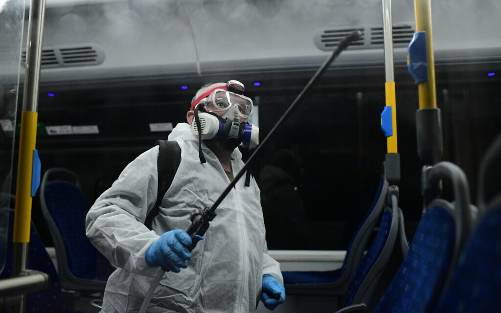 Workers wearing protective suits disinfect a bus as a preventive measure amid fears over the spread of the coronavirus, in Tel Aviv  Photo by: Tomer Neuberg-JINIPIX