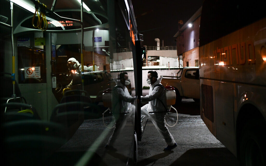 Workers wearing protective suits disinfect a bus as a preventive measure amid fears over the spread of the coronavirus, in Tel Aviv on March 9, 2020, "After a day of complex discussions, we made a decision: everyone who comes to Israel from abroad will enter the 14-day isolation," Mr Netanyahu said in a statement. Photo by: Tomer Neuberg-JINIPIX