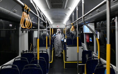 Workers wearing protective suits disinfect a bus as a preventive measure amid fears over the spread of the coronavirus, in Tel Aviv  Photo by: Tomer Neuberg-JINIPIX