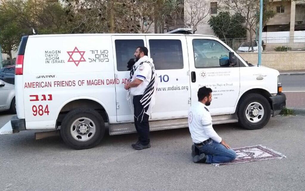 Avraham Mintz and Zoher Abu Jama praying together