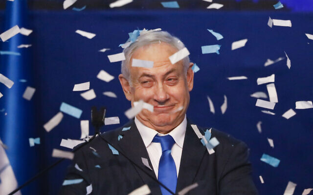 Israeli Prime Minister Benjamin Netanyahu smiles after first exit poll results for the Israeli elections at his party's headquarters in Tel Aviv, Israel, Monday, Feb. 2, 2020. (AP Photo/Ariel Schalit)