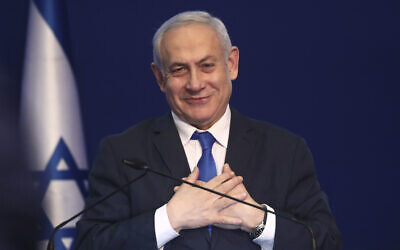 Israeli Prime Minister Benjamin Netanyahu addresses his supporters after first exit poll results for Israeli elections in Tel Aviv, Israel, Monday, March 2, 2020. (AP Photo/Oded Balilty)