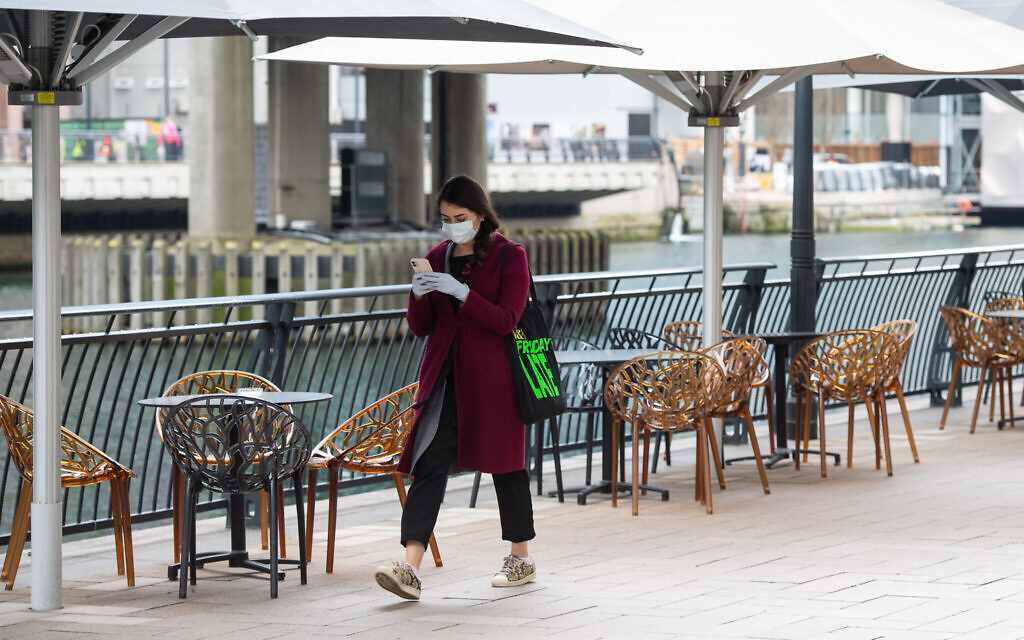 A woman wearing a protective face mask and gloves   (Photo credit: Dominic Lipinski/PA Wire)