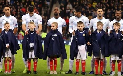 Picture posted online by the Israeli FA, depicting Israeli players in a previous fixture against Scotland, with Scottish ball-boys wearing the Israeli FA's jackets.