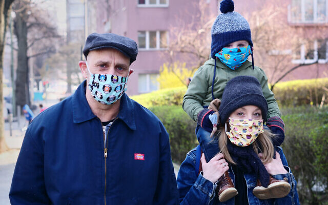 Family wearing a mask to protect others from the virus