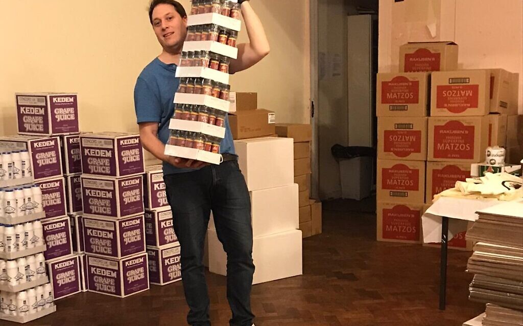 Tribe’s Barry Coleman helps pack the United Synagogue Pesach food parcels for community members in need