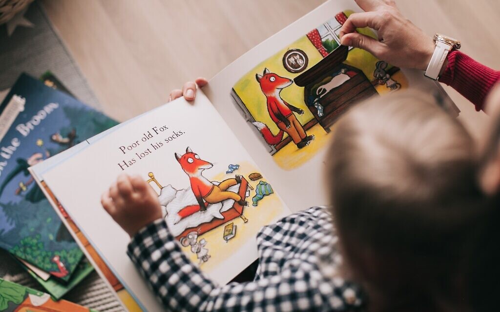 Clinical psychologist Karent Millet offers advice to parents during the pandemic. Pictured is a stock photo of a person reading with a child. (Credit: Pexels)