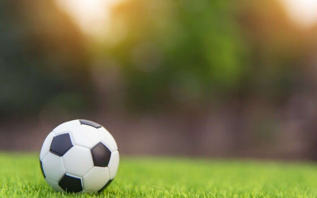 Football (Photo by Tevarak Phanduang on Unsplash)