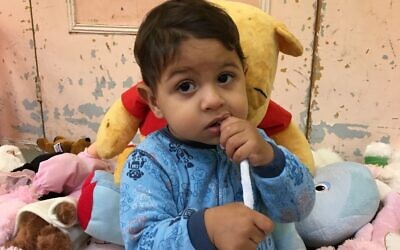 An asylum seeker’s child, who has not been named, being supported by United Synagogue