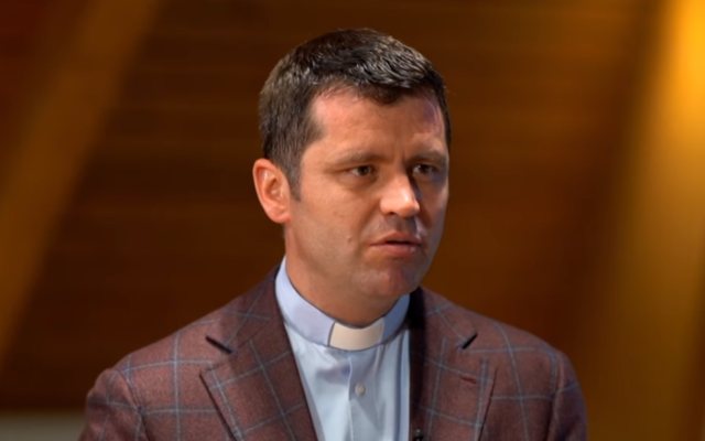 Romanian Catholic priest Francisc Dobos, the spokesperson for the Archdiocese of Bucharest, in 2019. (Screenshot: YouTube via Times of Israel)