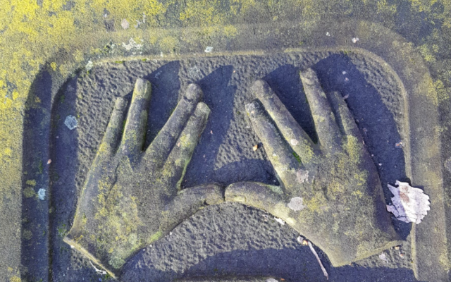 Hands imprinted on a Novo cemetery grave