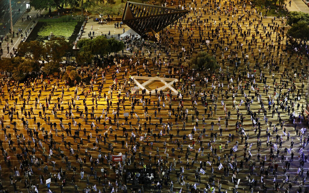 People keep social distance amid concerns over the country's coronavirus outbreak, during a protest against Prime Minister Benjamin Netanyahu and Benny Gantz and government corruption, at Rabin square in Tel Aviv, Israel, Saturday, May 2, 2020. .(AP Photo/Ariel Schalit)