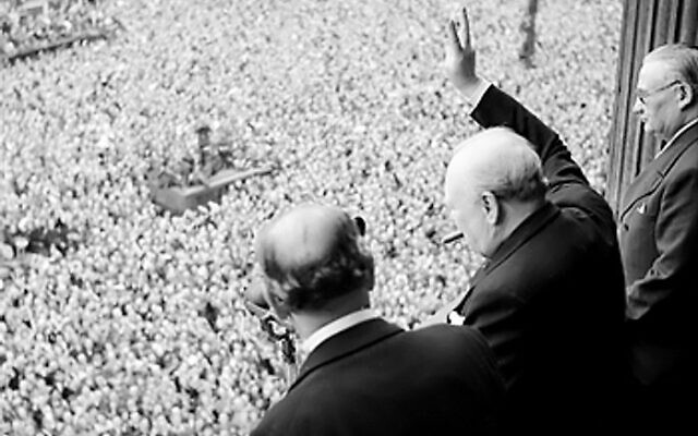 Former PM Winston Churchill waves to crowds in Whitehall on VE Day, 8 May 1945 (Credit: Public Domain, Wikimedia Commons)