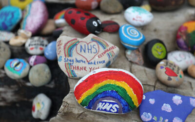 Painted pebbles showing support for the NHS and keyworkers, and containing positive messages