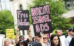 Protestors with signs urging the boycott of Israel Protestors with signs urging the boycott of Israel