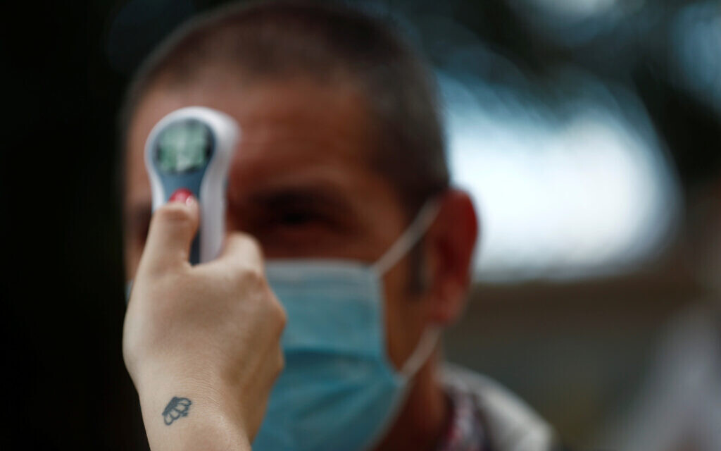 Someone has their temperature checked amid the coronavirus outbreak