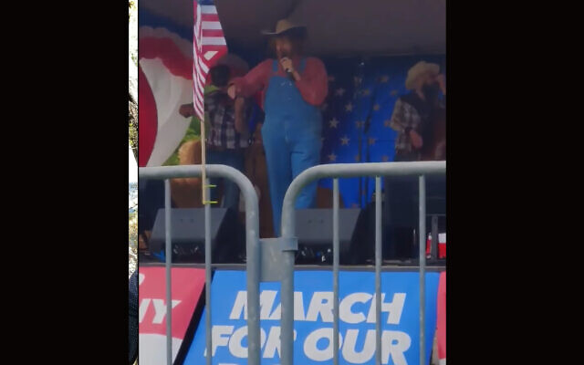 Comedian Sacha Baron Cohen performed a song with racist and conspiracy theory-laden lyrics at a far-right rally in Olympia, Washington, June 27, 2020. (Screenshot from YouTube via JTA)