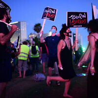 An anti-government protester clad in mask due to the COVID-19 coronavirus pandemic chants slogans during a demonstration in Charles Clore Park in the Mediterranean coastal city of Tel Aviv on July 18, 2020, protesting against the Israeli government and the PM for the broken promises made by the Israeli government during the novel coronavirus pandemic Photo by: Tomer Neuberg-JINIPIX