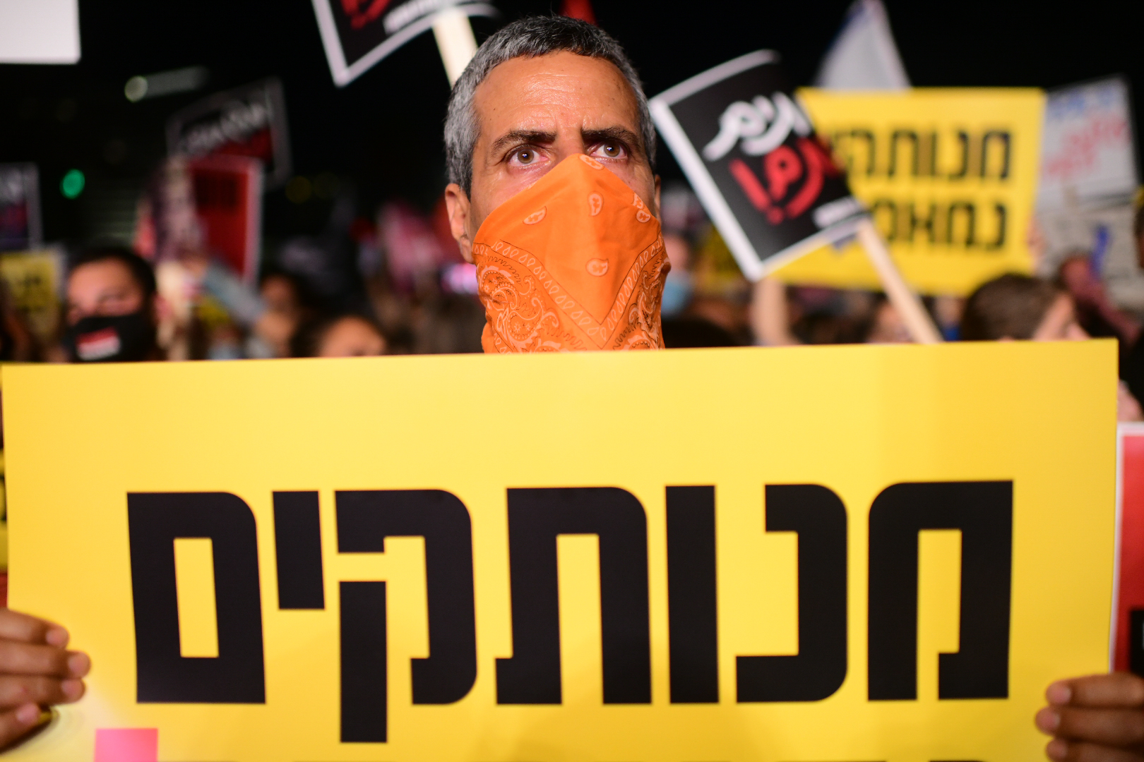 An anti-government protester clad in mask due to the COVID-19 coronavirus pandemic chants slogans during a demonstration in Charles Clore Park in the Mediterranean coastal city of Tel Aviv on July 18, 2020, protesting against the Israeli government and the PM for the broken promises made by the Israeli government during the novel coronavirus pandemic Photo by: Tomer Neuberg-JINIPIX