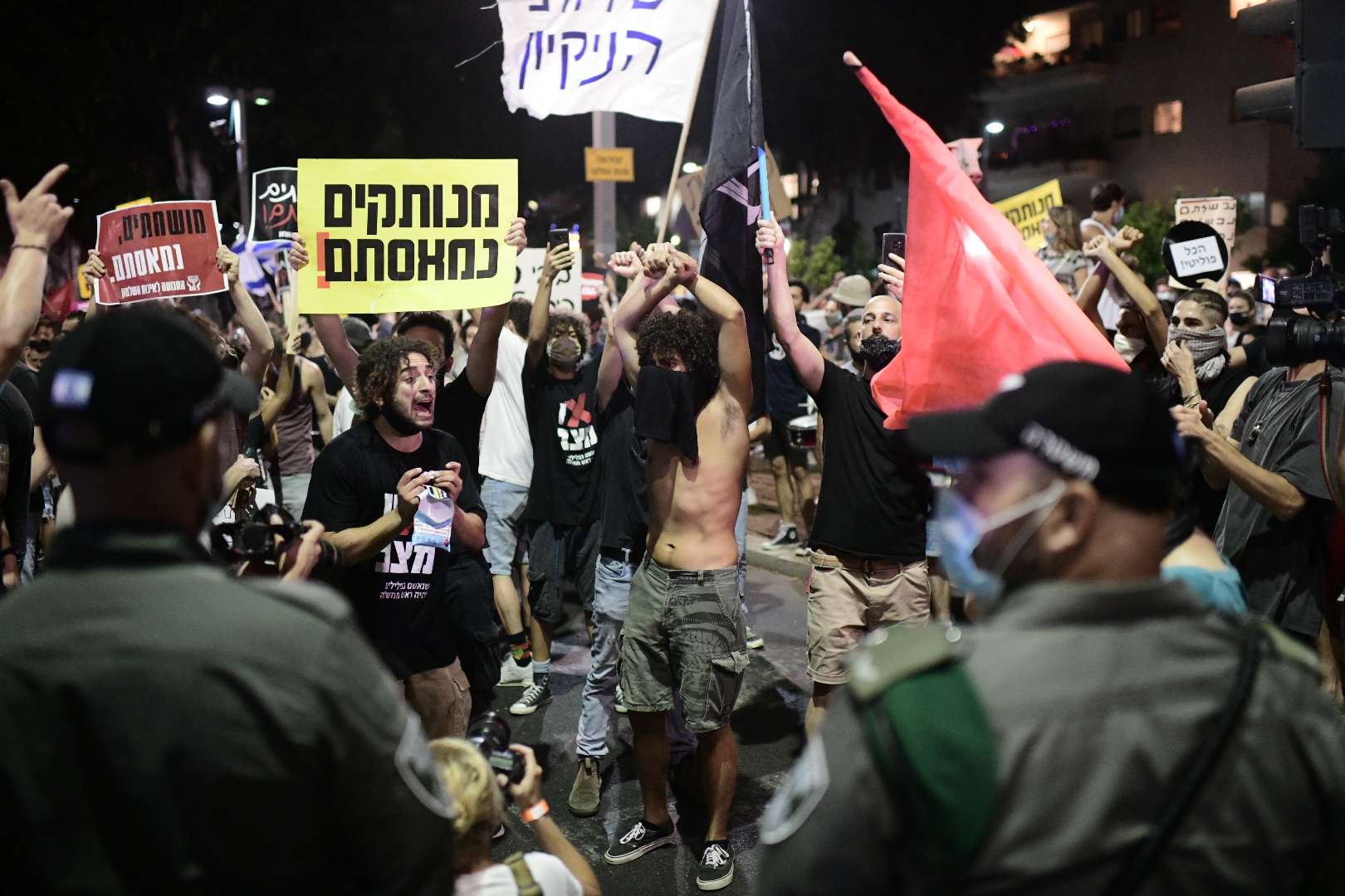 Israelis wearing protective face masks due to the COVID-19 coronavirus pandemic, take part in a demonstration on July 18, 2020, in the Israeli coastal city of Tel Aviv to protest against the Israeli government and Prime Minister Benjamin Netanyahu for the broken promises made by the Israeli government during the Covid-19 pandemic. - Israel's government said today it was imposing new restrictions to limit the spiraling spread of coronavirus in the hope of avoiding a general lockdown further along the line. Photo by: Tomer Neuberg-JINIPIX