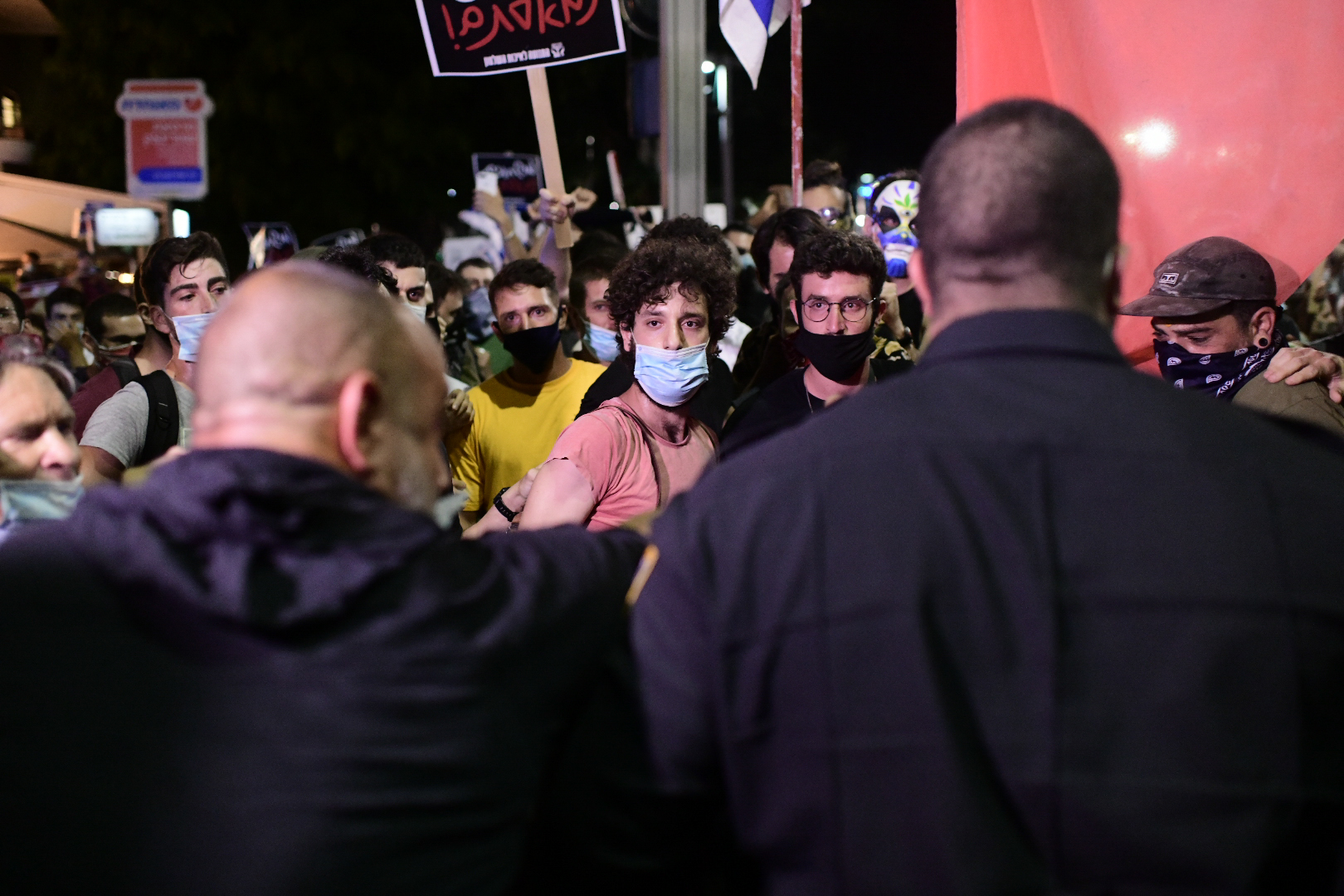 Israelis wearing protective face masks due to the COVID-19 coronavirus pandemic, take part in a demonstration on July 18, 2020, in the Israeli coastal city of Tel Aviv to protest against the Israeli government and Prime Minister Benjamin Netanyahu for the broken promises made by the Israeli government during the Covid-19 pandemic. - Israel's government said today it was imposing new restrictions to limit the spiraling spread of coronavirus in the hope of avoiding a general lockdown further along the line. Photo by: Tomer Neuberg-JINIPIX