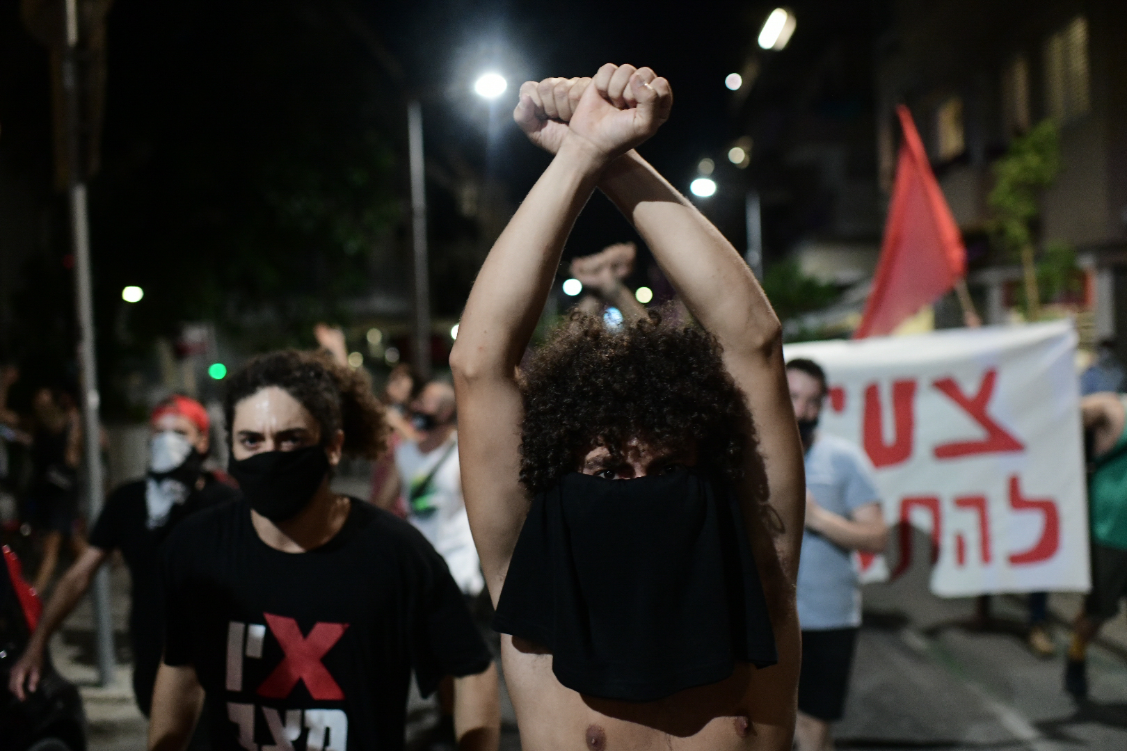 Israelis wearing protective face masks due to the COVID-19 coronavirus pandemic, take part in a demonstration on July 18, 2020, in the Israeli coastal city of Tel Aviv to protest against the Israeli government and Prime Minister Benjamin Netanyahu for the broken promises made by the Israeli government during the Covid-19 pandemic. - Israel's government said today it was imposing new restrictions to limit the spiraling spread of coronavirus in the hope of avoiding a general lockdown further along the line. Photo by: Tomer Neuberg-JINIPIX