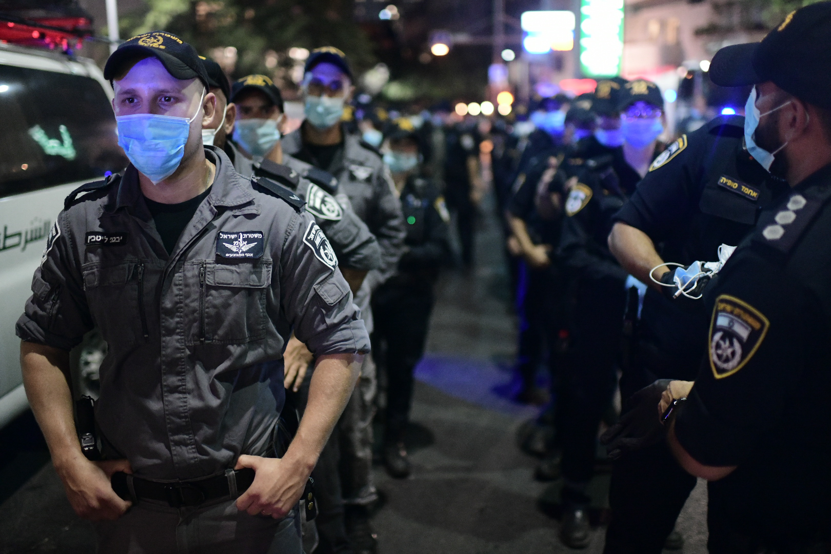 Israeli protesters wearing protective face masks due to the COVID-19 coronavirus pandemic, clash with police during a demonstration on July 18, 2020, in the Israeli coastal city of Tel Aviv to protest against the Israeli government and Prime Minister Benjamin Netanyahu for the broken promises made by the Israeli government during the Covid-19 pandemic. - Israel's government said today it was imposing new restrictions to limit the spiraling spread of coronavirus in the hope of avoiding a general lockdown further along the line. Photo by: Tomer Neuberg-JINIPIX