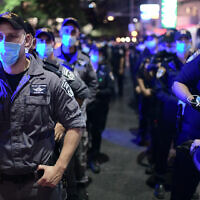 Israeli protesters wearing protective face masks due to the COVID-19 coronavirus pandemic, clash with police during a demonstration on July 18, 2020, in the Israeli coastal city of Tel Aviv to protest against the Israeli government and Prime Minister Benjamin Netanyahu for the broken promises made by the Israeli government during the Covid-19 pandemic. - Israel's government said today it was imposing new restrictions to limit the spiraling spread of coronavirus in the hope of avoiding a general lockdown further along the line. Photo by: Tomer Neuberg-JINIPIX