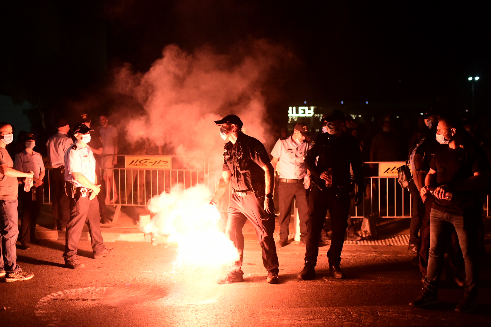 Israeli protesters wearing protective face masks due to the COVID-19 coronavirus pandemic, clash with police during a demonstration on July 18, 2020, in the Israeli coastal city of Tel Aviv to protest against the Israeli government and Prime Minister Benjamin Netanyahu for the broken promises made by the Israeli government during the Covid-19 pandemic. - Israel's government said today it was imposing new restrictions to limit the spiraling spread of coronavirus in the hope of avoiding a general lockdown further along the line. Photo by: Tomer Neuberg-JINIPIX