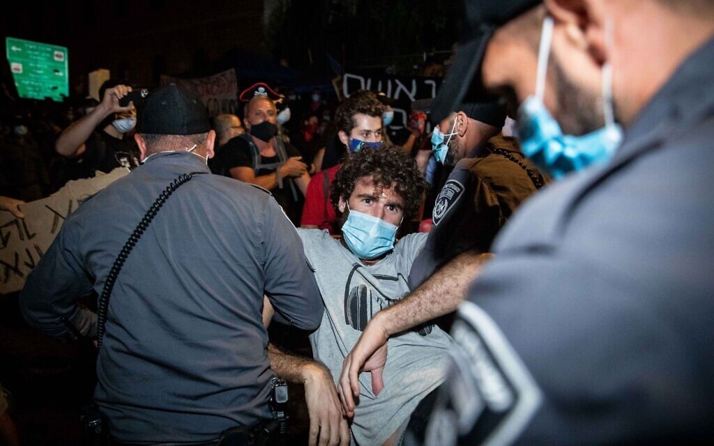 Israeli police remove protesters during a protest against Israeli prime minister Benjamin Netanyahu outside the prime minister's residence in Jerusalem on July 26, 2020. Photo by: JINIPIX