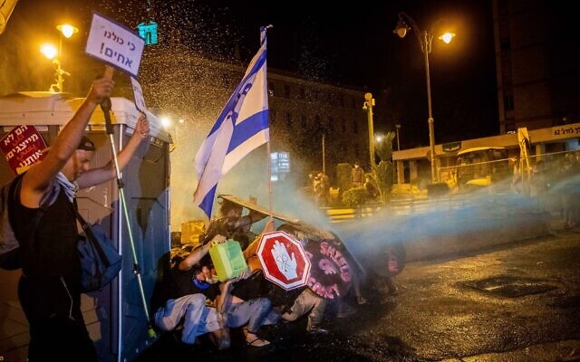 Israeli Police use a water cannon to disperse demonstrators during a protest against Israeli prime minister Benjamin Netanyahu outside the prime minister's residence in Jerusalem on July 26, 2020. Photo by: JINIPIX